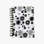 Load image into Gallery viewer, 5x7 Spiral B&amp;W Flowers Journal. Top view of cover shown. Varied, stylized drawings of flowers outlined and filled with black on a white background. Shop a selection of notebooks &amp; journals at blueigloo.ca 
