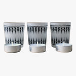 Load image into Gallery viewer, Damask Frosted Tea Light Holder-Set 3. A set of three frosted glass tea light holders with a black damask pattern. Shown in a straight line left to right with an inch between each holder with a single tea light in front of each holder on a white background. Shop tea light holders, decor, and decorative objects online at blueigloo.ca.

