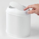 Load image into Gallery viewer, Vanity Waste Can by Inter Design. Front angled view of waste can with female hand pushing swing lid down with her index finger on an off white background. Shop vintage &amp; new home décor, lighting &amp; home furnishings as well as novelty gifts &amp; pet accessories online at blueigloo.ca
