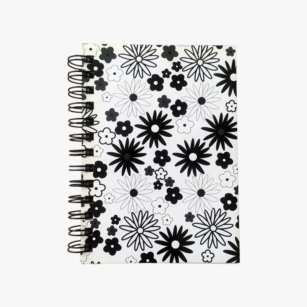 5x7 Spiral B&W Flowers Journal. Top view of cover shown. Varied, stylized drawings of flowers outlined and filled with black on a white background. Shop a selection of notebooks & journals at blueigloo.ca 