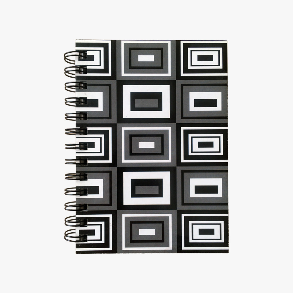 5x7 Spiral B&W Rectangles Journal. Top view of cover shown. Varied, black and white geometric rectangles outlined in white and black on a  grey background. Shop a selection of notebooks & journals at blueigloo.ca