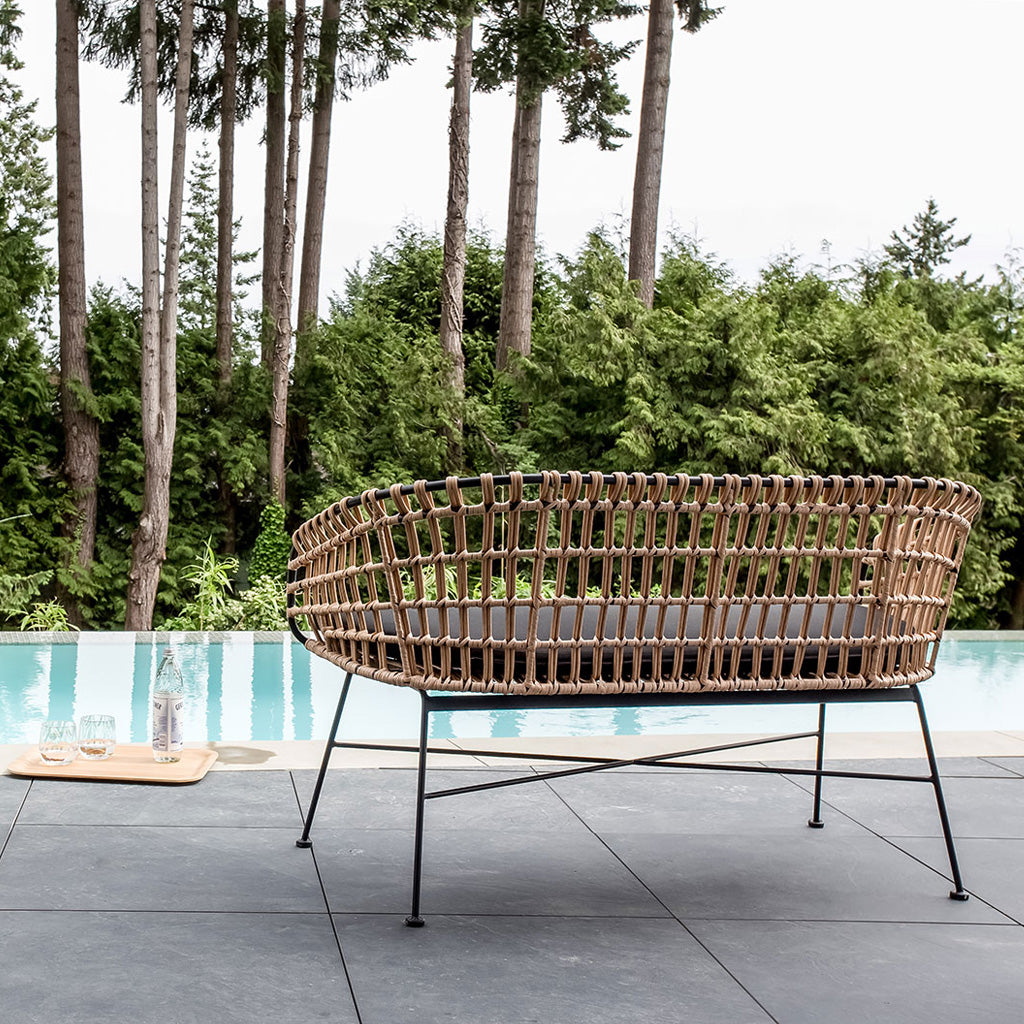 Calabria Bench by Style In Form. Shown in Natural / Black. Back view of bench on pool deck with pool and trees in the background. Shop vintage & new home décor, lighting & home furnishings as well as novelty gifts & pet accessories online at blueigloo.ca