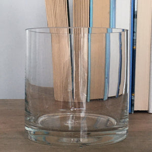 Cylinder Glass Bud Vase. Front view with book spines visible in the background through the vase. Shop vintage & new home décor, lighting & home furnishings as well as novelty gifts & pet accessories online at blueigloo.ca