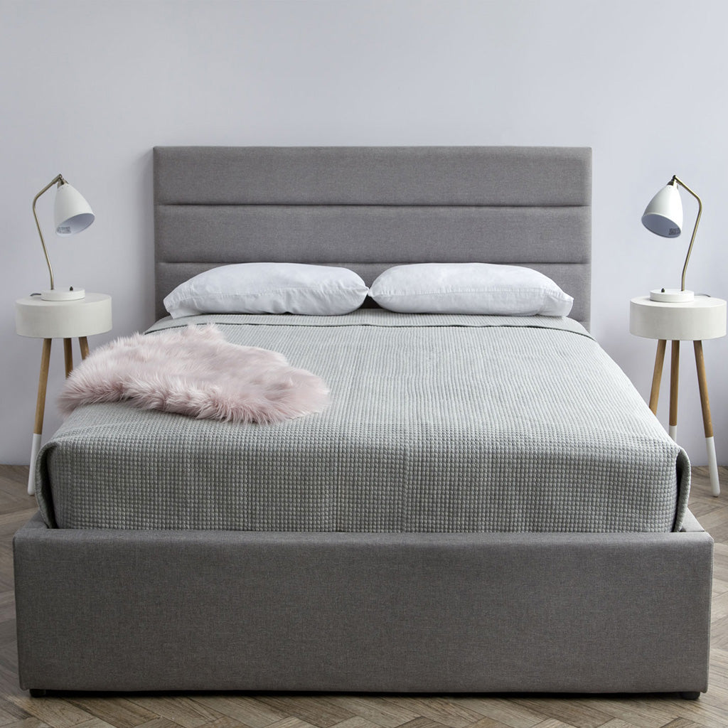 Justin Storage Bed, Greige by Style In Form. Lifestyle shot showing dressed bed in room with 2 side tables with white MCM style lamps on top tables. View from end of bed. Shop vintage & new home décor, lighting & home furnishings as well as novelty gifts & pet accessories online at blueigloo.ca