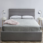Load image into Gallery viewer, Justin Storage Bed, Greige by Style In Form. Lifestyle shot showing dressed bed in room with 2 side tables with white MCM style lamps on top tables. View from end of bed. Shop vintage &amp; new home décor, lighting &amp; home furnishings as well as novelty gifts &amp; pet accessories online at blueigloo.ca
